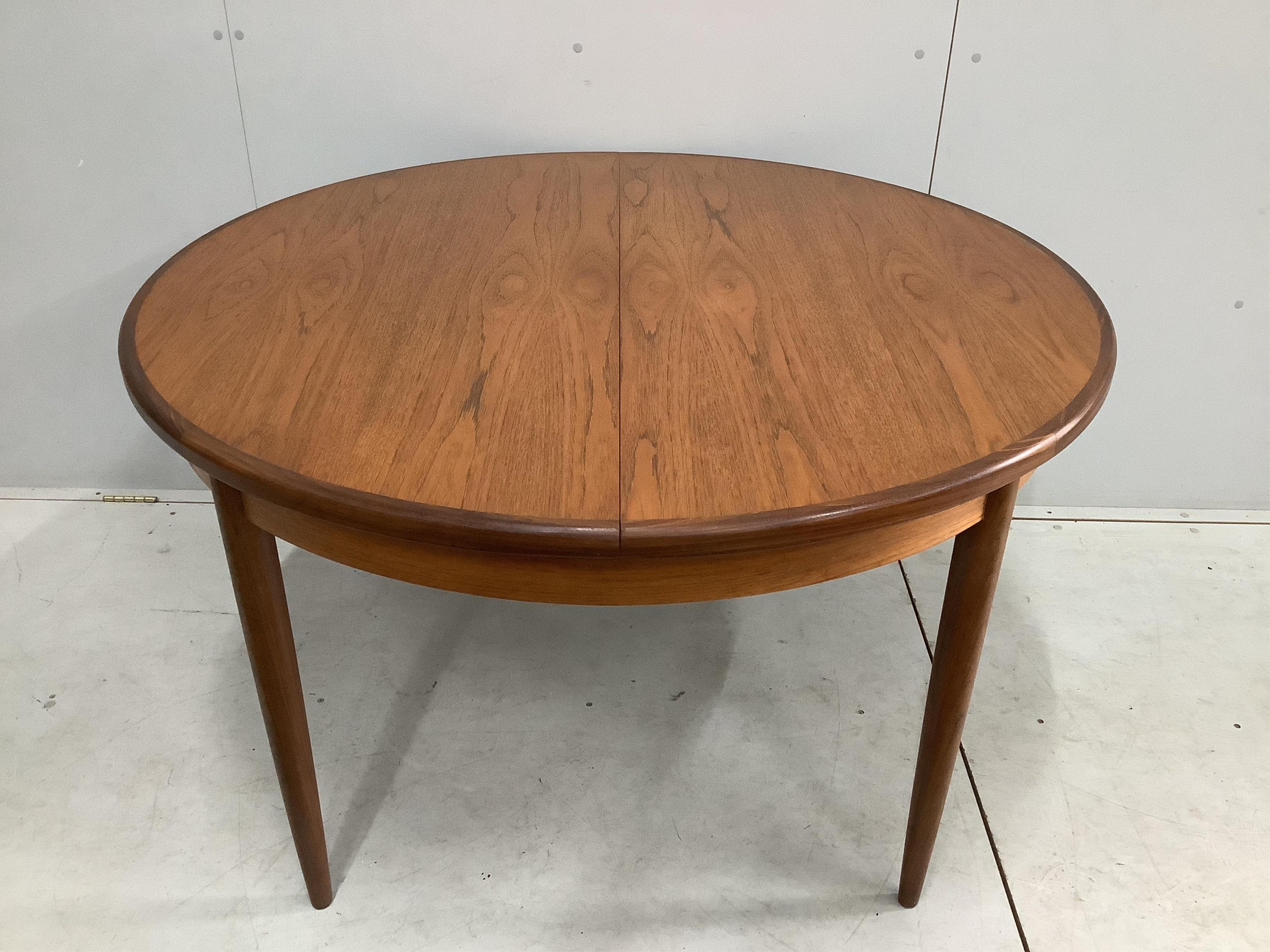 A G Plan Fresco teak dining table and five chairs, one with arms. Table 170cm extended, depth 120cm, height 73cm. Condition good.